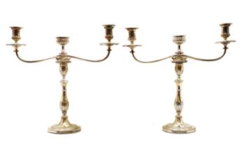 A pair of silver candlesticks,