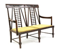 An Egyptian Revival stained beech hall seat,