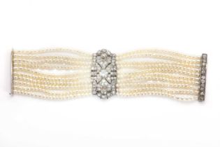 An Art Deco cultured pearl bracelet with a diamond set plaque,