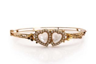 A Victorian double heart moonstone and seed pearl bangle,