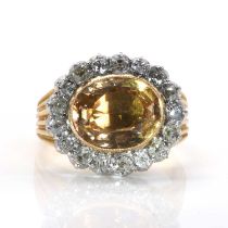 A foiled topaz and diamond oval cluster ring,