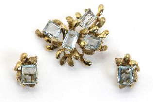 An aquamarine and gold brooch and earrings suite,
