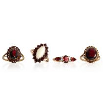 A group of four garnet rings,