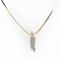 A two colour gold diamond leaf design pendant and chain,