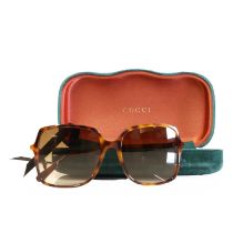 A pair of Gucci faux tortoiseshell sunglasses and a pair of Chloe sunglasses