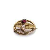 A gold garnet foliate brooch,