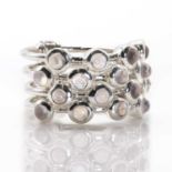 A silver moonstone four band ring,