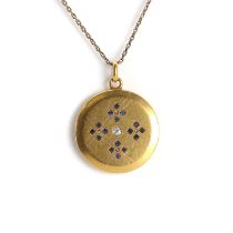 A 1920s diamond and sapphire set circular locket,