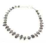 A silver tourmalinated quartz necklace,