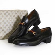 A pair of men's Gucci black leather loafers,