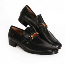 A pair of Gucci men's black leather loafers,