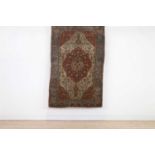 A Persian wool rug,