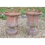 A pair of Gothic style terracotta urns