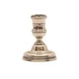 A cast silver dwarf candlestick