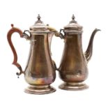 A silver coffee pot and hot water jug