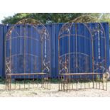 A pair of wrought iron arbour seats