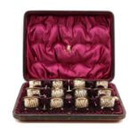 A cased set of twelve silver salts and spoons