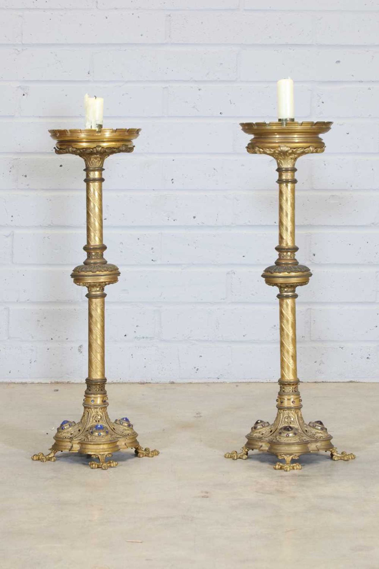 A pair of tall brass candlesticks,
