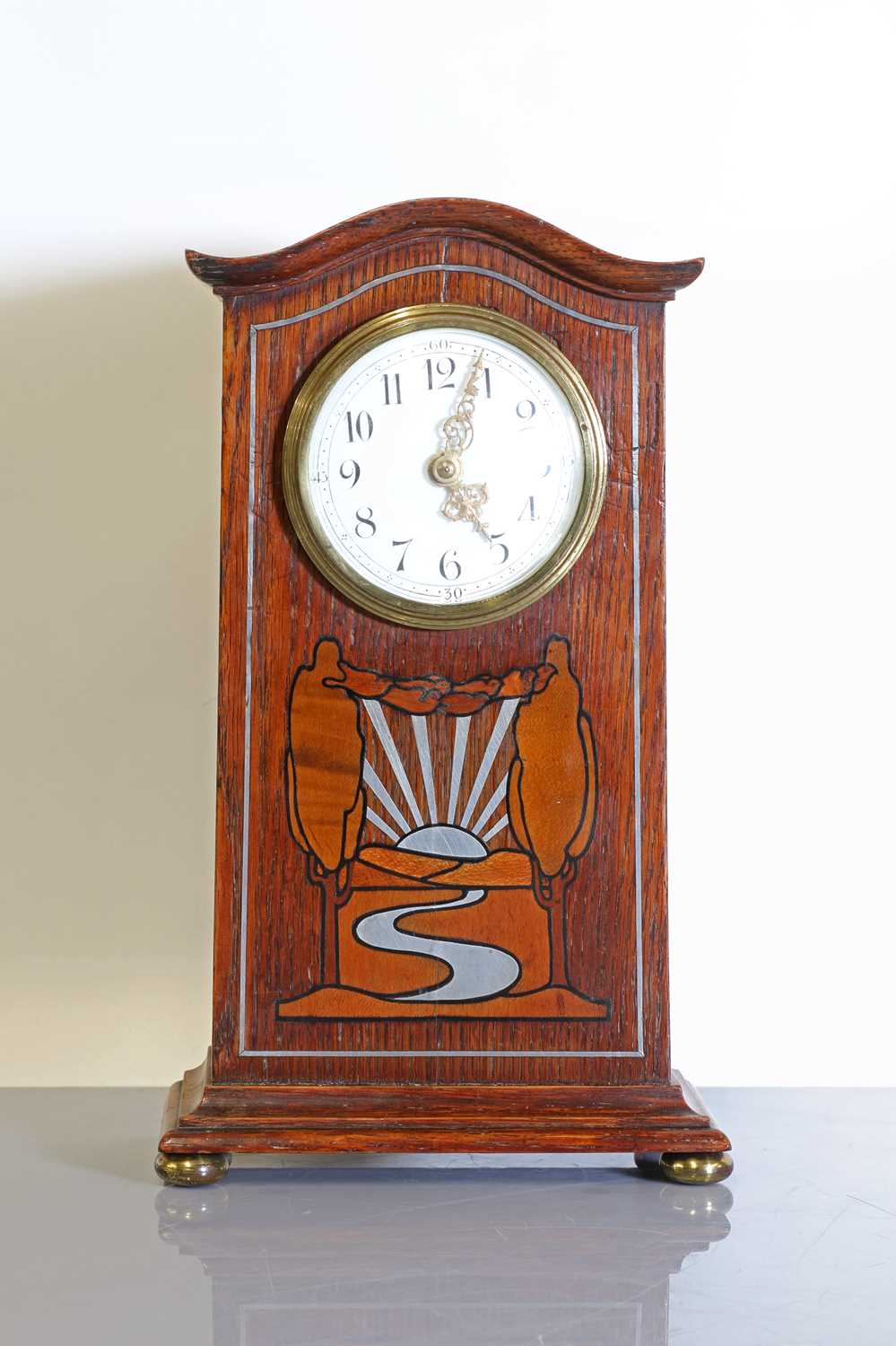 An oak-inlaid and pewter-mounted mantel clock,