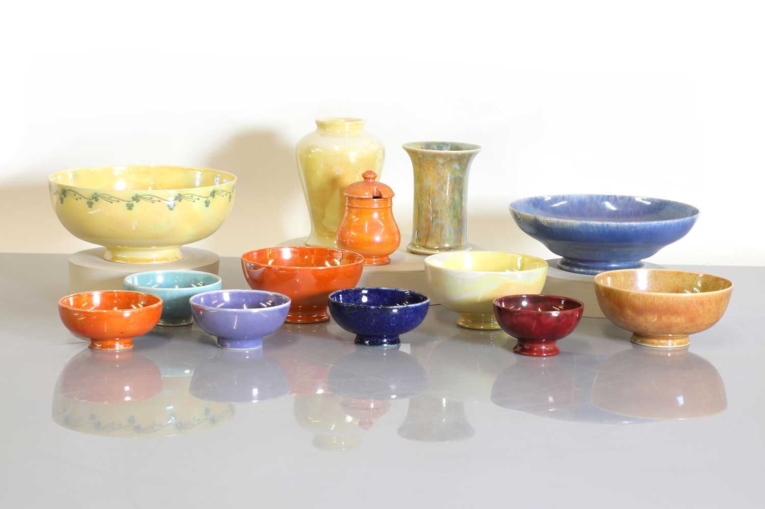 A collection of Ruskin and Moorcroft lustre bowls, a vase, and a pot and cover,
