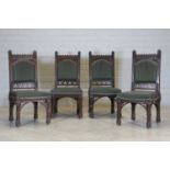 A set of four Gothic oak single dining chairs