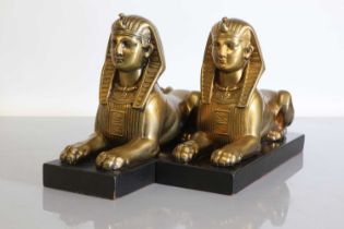 A pair of Art Deco patinated bronze sphinxes,