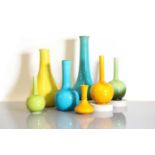 A collection of seven Burmantofts Pottery coloured vases,