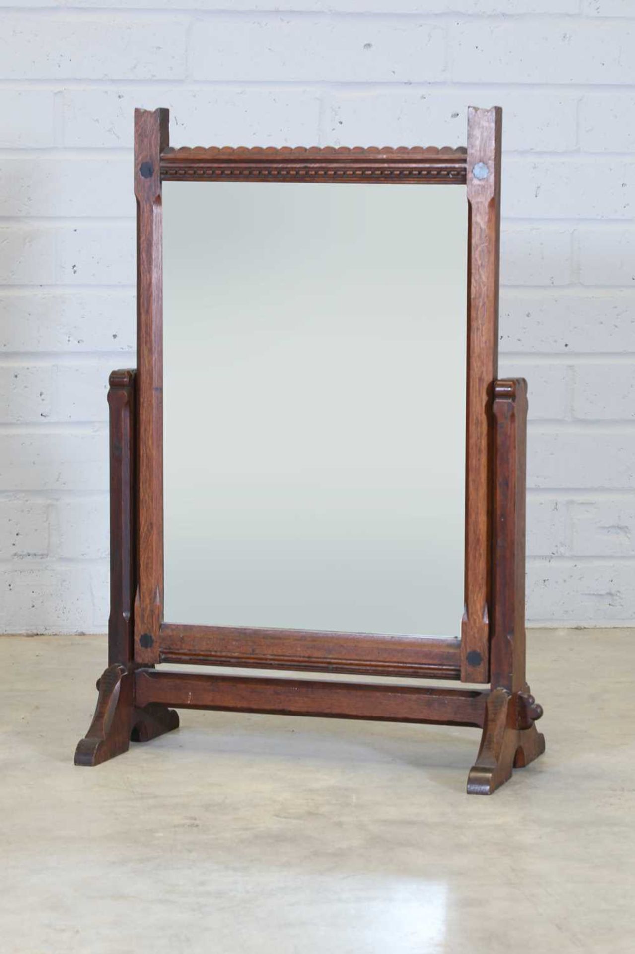 An Arts and Crafts oak dressing mirror,