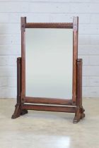 An Arts and Crafts oak dressing mirror,