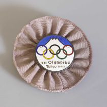 A silvered and enamelled Olympic Games badge,