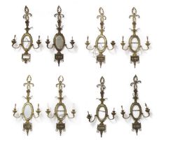 A set of eight Neoclassical style brass twin branch wall appliques,