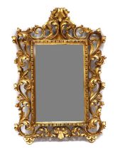 A carved giltwood mirror in the Florentine-style,