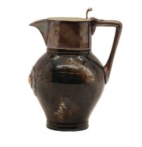 A silver plated porcelain jug