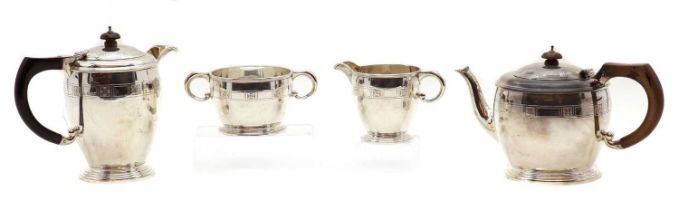 A silver three piece tea service