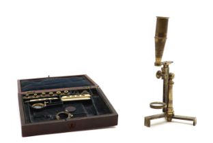 A cased brass field microscope,