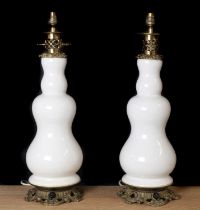 A pair of earthenware and brass mounted table lamps