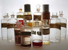 A group of clear glass apothecary bottles