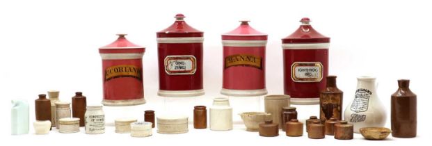 A group of four ceramic apothecary jars