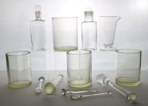 A large collection of glass apothecary bottles
