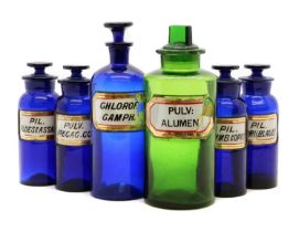A collection of glass apothecary bottles,