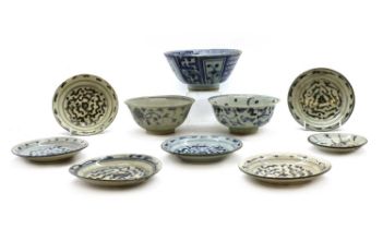 A collection of blue and white pottery saucers and bowls,