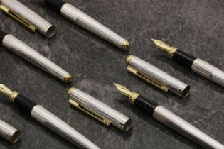 A group of five silver fountain pens