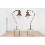 A pair of large painted metal lamps,