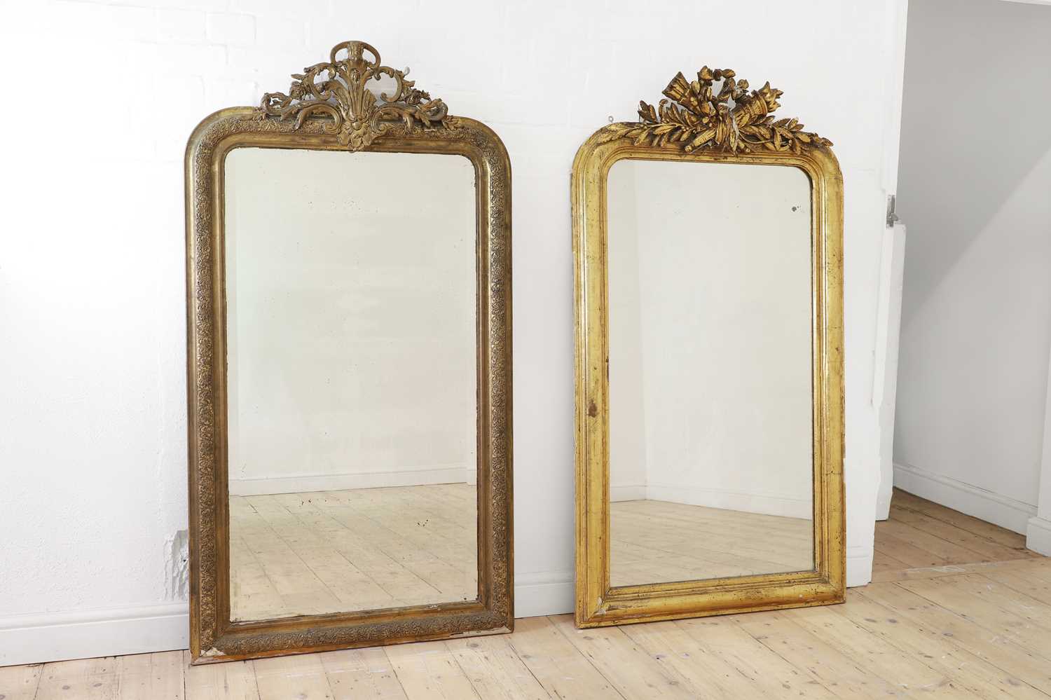 A near pair of giltwood and gesso overmantel mirrors,