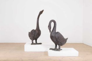 A pair of patinated bronze geese,