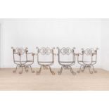 A set of four wrought-iron garden chairs,