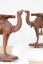 A near pair of teak camel occasional tables,