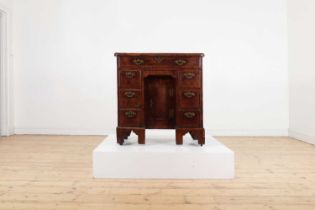 A George II walnut and feather-banded kneehole desk,