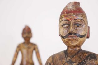 A near pair of carved and painted figures,