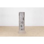 A white and black grained marble column,